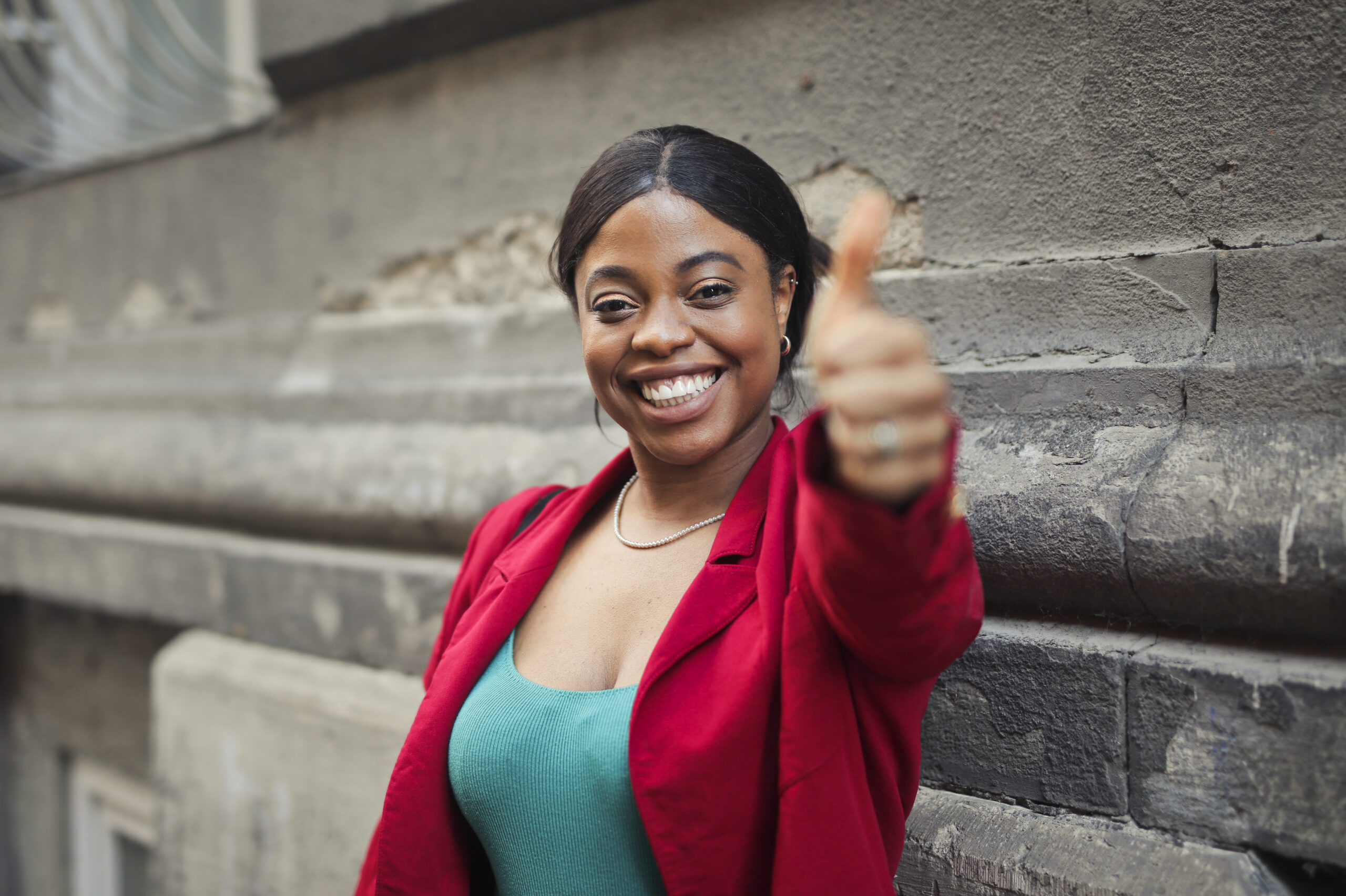 portrait smiling woman with thumb up scaled.jpg