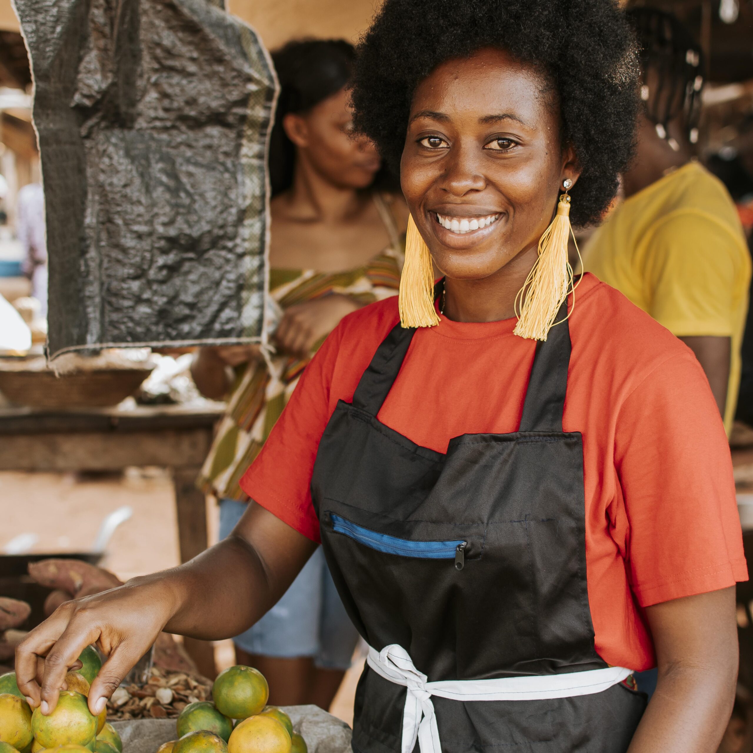 smiley african woman working market scaled.jpg
