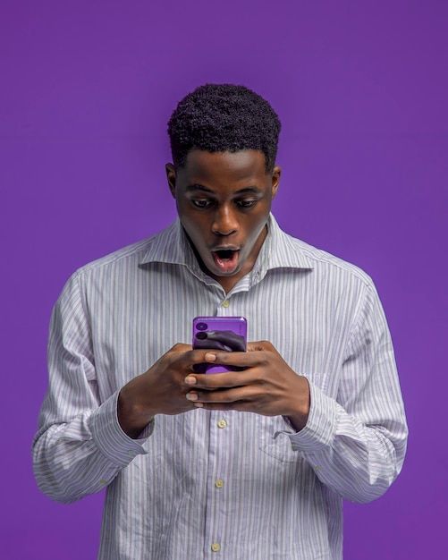 a man pressing his smartphone in excitement premium photo