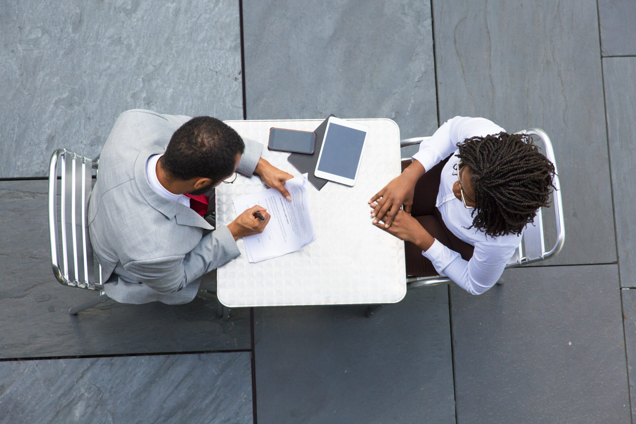 business man signing documents during meeting with partner
